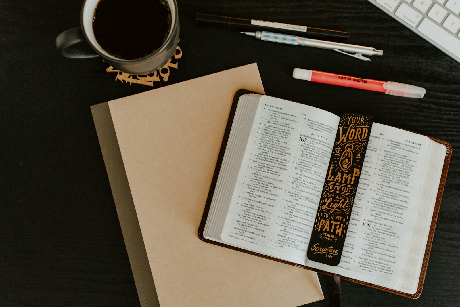Open Bible, coffee and writing tools representing encouragement and spiritual support