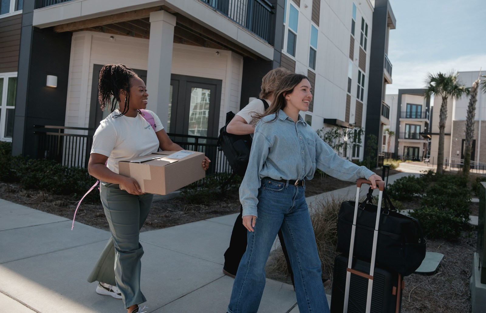 People carrying boxes together representing practical ministry support
